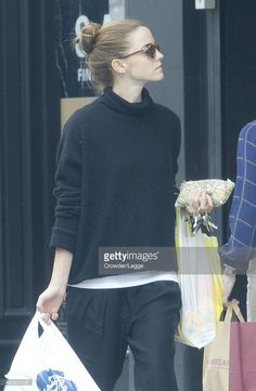 a woman walking down the street carrying shopping bags