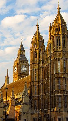 the big ben clock tower towering over the city of london on a partly cloudy day