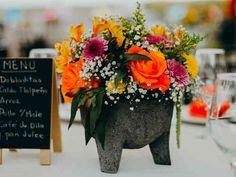 an elephant shaped planter with flowers on the head is set up for a wedding reception