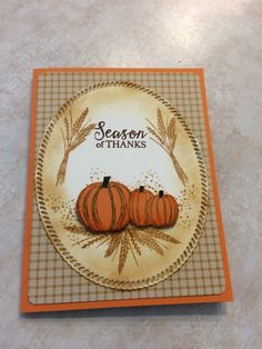 a card with two pumpkins on it and the words season of thanks written in orange