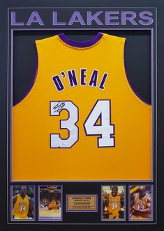 an autographed lakers jersey is displayed in a black frame