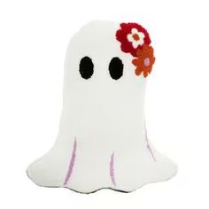 a white stuffed ghost with red flowers on it's head and eyes, sitting in front of a white background