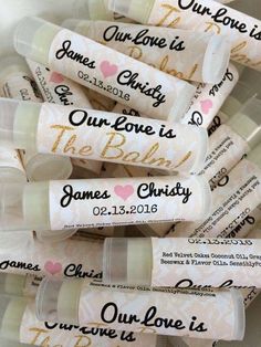 personalized lip bales with names and hearts on them in clear plastic containers for wedding favors