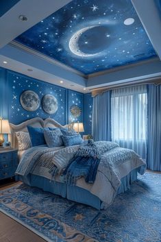 a bedroom decorated in blue with stars and moon designs on the ceiling, along with a large bed