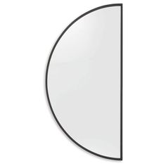 a mirror that is on the wall with a black frame and an oval shaped design