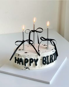 a birthday cake with lit candles on it