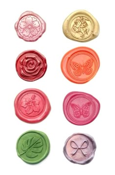 six wax seals with different designs and colors on them, including one for the butterfly