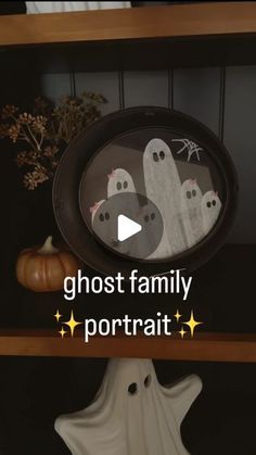 the ghost family portrait is displayed on a shelf