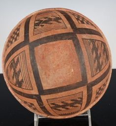 a brown and black bowl sitting on top of a table