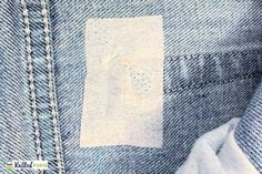 a piece of cloth is sticking out of the back pocket of a pair of jeans