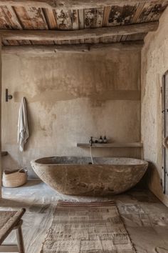 a large stone bath tub in a rustic bathroom