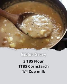 a spoon full of gravy sitting on top of a pot filled with soup