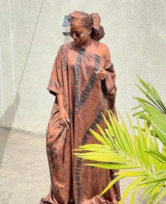 🎈This Nigerian Bubu Dress is made of high-quality adire silk (Nigerian tie-dye) that feels good on the skin. Look simple, yet sophisticated enough to steal all the attention in this gorgeous Kaftan. 🎈Details -Size: Loose fit customized to your size. This dress is made for you - 2 Side Pockets -Length 58 inches (can be adjusted to your desired length) -Neckline: Off Shoulder/ Slant Shoulder -100% West African Silk -Fabric is hand-dyed in Nigeria -Handmade in Nigeria - Soft on the skin & flowy - Brown Silk Wedding Dress, Traditional Silk Dresses With Batik Print, Lace Combination Styles Gown, Bridesmaid Asoebi, Nigeria Wedding Dress, Bubu Gown, Singer Dr, Nigeria Wedding, Boubou Styles For Women