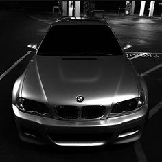 a silver car parked in a parking lot at night