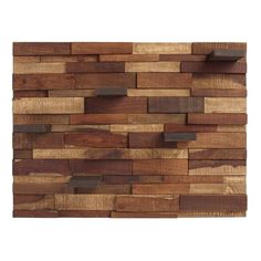 a wooden wall hanging on the side of a white wall with lots of wood planks