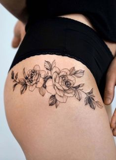 a woman's thigh with flowers on it