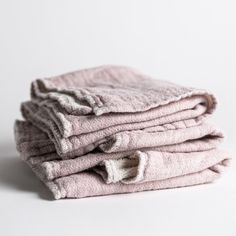 a stack of towels folded on top of each other in front of a white background