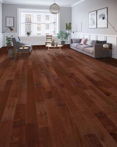 a living room filled with furniture and hardwood flooring on top of a hard wood floor