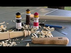 several different types of wood shavings on a table next to a knife and pencil