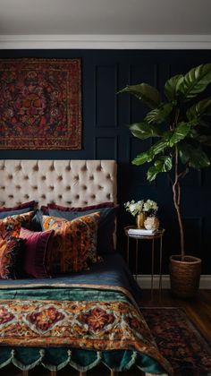 a bedroom with blue walls and colorful bedding