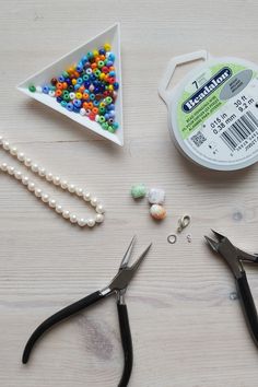 scissors, beads, and other crafting supplies laid out on a table