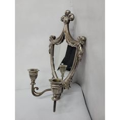 an ornately decorated wall mirror and candle holder