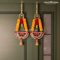 the earrings are adorned with beads and tassels on each earring, along with flowers