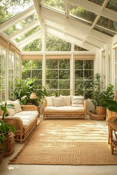 a sun room with wicker furniture and plants