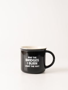 a black and white coffee mug with the words may the bridges bridge over burn light the way