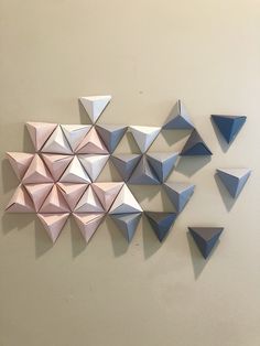 several origami shapes are arranged on the wall