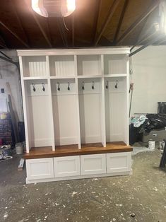 a room filled with lots of white cabinets