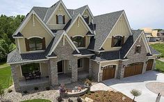 an aerial view of a large house with lots of windows and stonework on the front