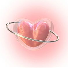 two heart shaped objects are in the shape of a saturn with rings around them on a pink background