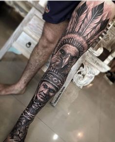 a man's leg with an eagle and headdress tattoo on his arm