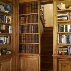 the bookshelves are filled with many different types of books and there is also a stair case