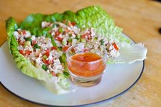 a lettuce leaf with some kind of sauce on it sitting on a plate