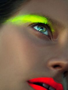 a woman with bright yellow and red makeup