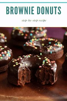 chocolate brownie donuts with sprinkles are on a wooden cutting board