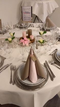 a table set with silverware and napkins for a formal dinner or banquet event