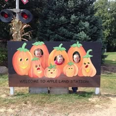 there is a sign that says welcome to appleland station with pumpkins on it