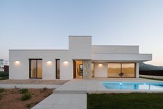 a house with a pool in front of it