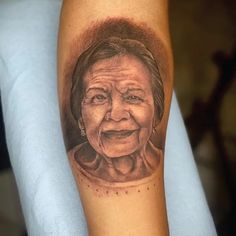 an old woman's face is shown on the arm, and it looks like she has