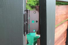 a close up of a door handle on a wooden fence