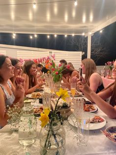 a group of people sitting around a table eating food