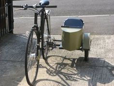 a bicycle parked next to a trash can