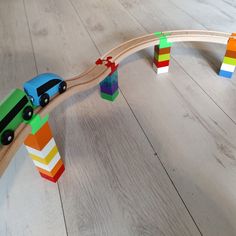 a wooden toy train set with cars and blocks