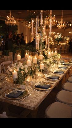 a long table is set with candles and flowers for an elegant dinner or party event