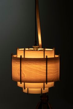 a lamp that is on top of a tripod with a light bulb in the middle