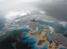 a boat floating on top of a large body of water covered in blue and orange paint