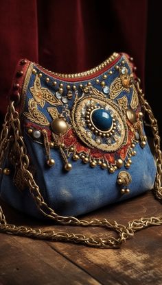 a blue purse sitting on top of a wooden table